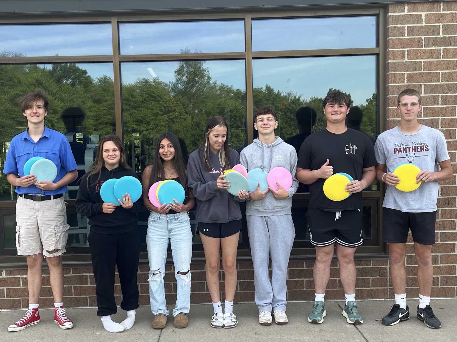 Veteran's Disc Club delivering donated disc golf equipment to Delton Kellogg High School