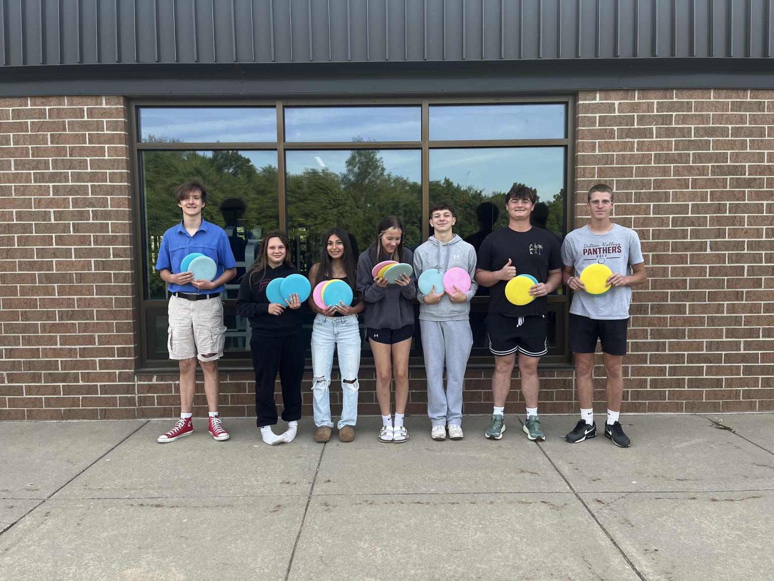 Students receiving donated disc golf equipment during the Delton Kellogg outreach project